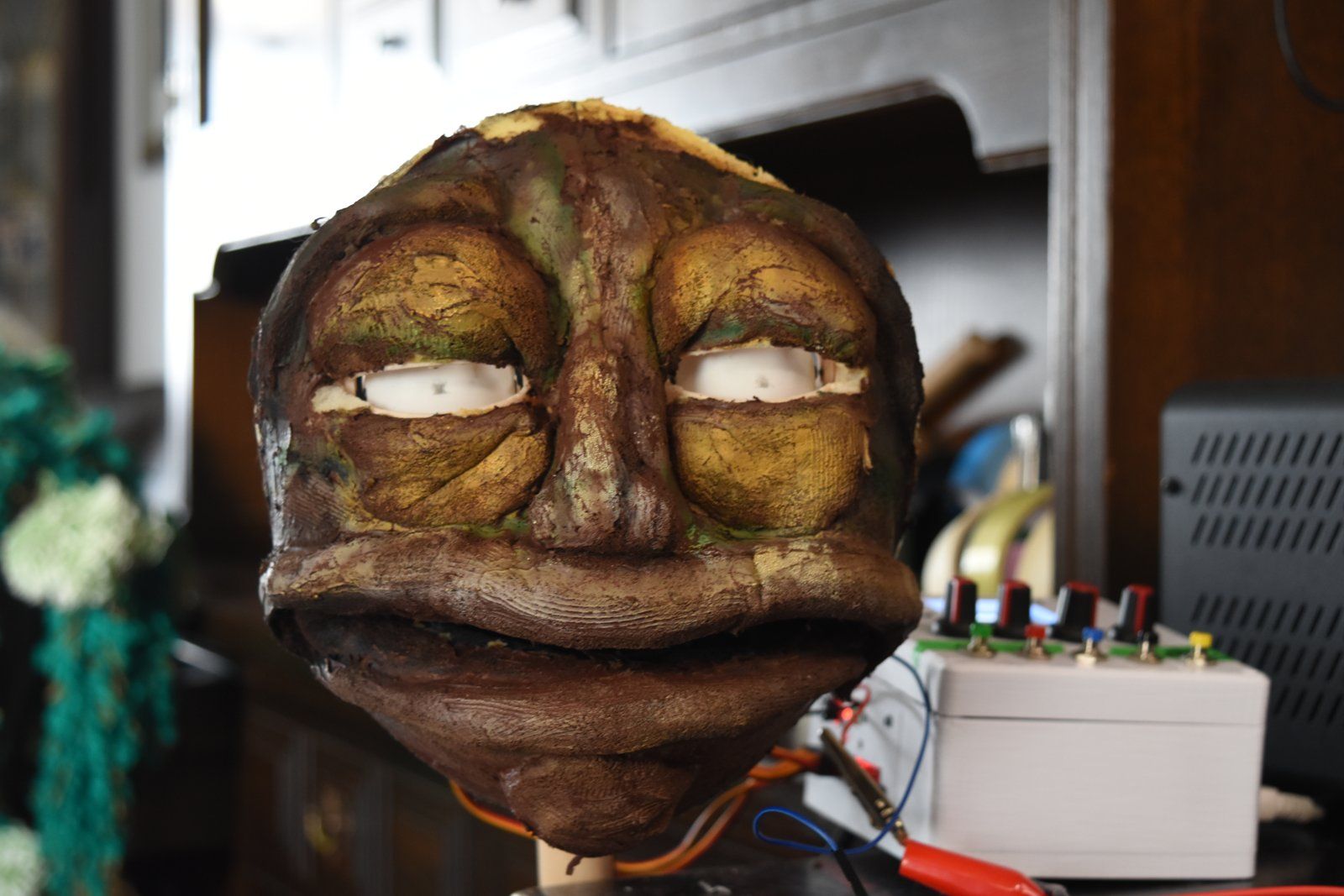 A face with its eyes fitted, wired up for testing.
