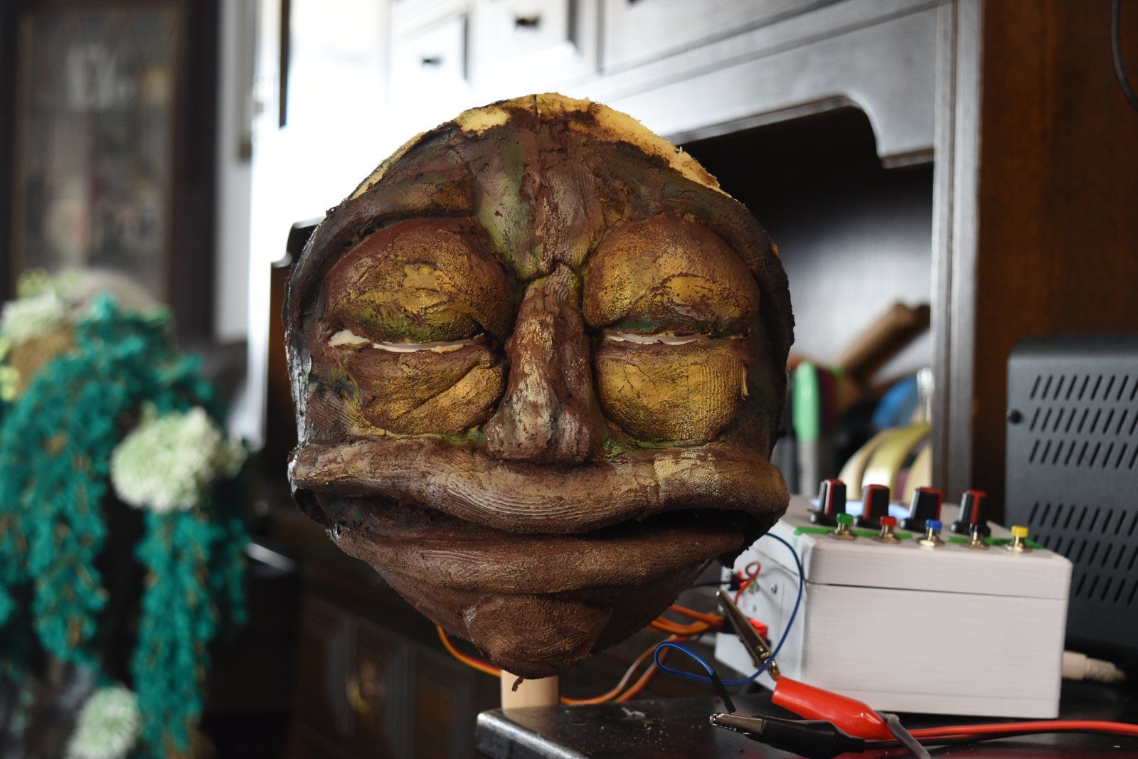 A finished face on the test stand with its eye and mouth mechanism.