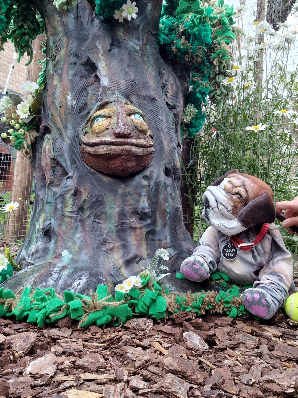 Oakley the tree puppet with Polly the dog at its roots